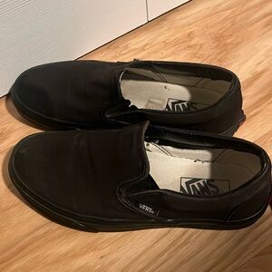 Vans all black slip-ons
